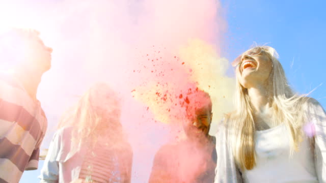 Multi-Ethnic-Group-of-Diverse-Diverse-Young-People-Jump-and-Throw-Colorful-Powder-in-the-Air-in-Celebration-of-Holi-Festival.-They-Have-Enormous-Fun-on-this-Sunny-Day.