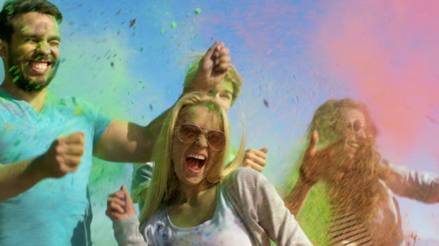 Multi-Ethnic-Group-of--Diverse-Young-People-Throw-Colorful-Powder-at-Each-other-in-Celebration-of-Holi-Festival.-They-Have-Enormous-Fun-on-this-Sunny-Day.