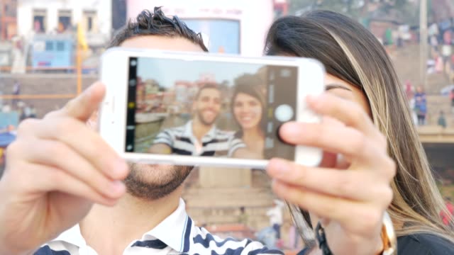 Couple-taking-a-selfie-in-Varanasi,-India