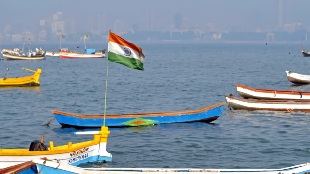Indian-flag-waving-on-parked-fishing-boat-in-Mumbai,-India
