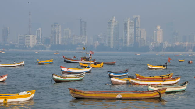 Indische-Fischer-Segeln-ein-Fischerboot-durch-andere-parkende-Fischerboote
