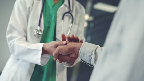 Health-worker-holding-patient's-hand