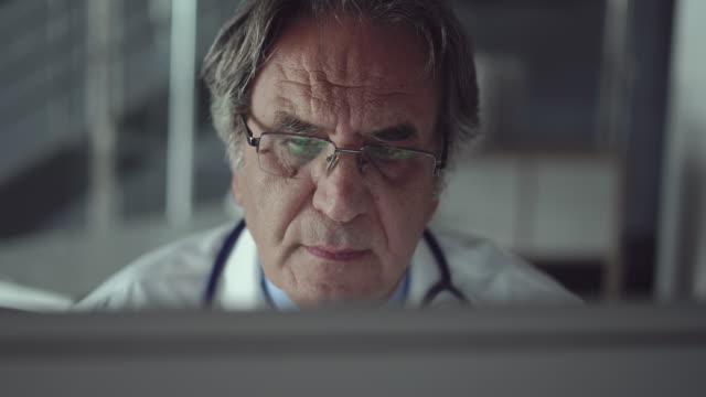 Doctor-working-with-laptop-computer