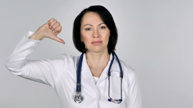 Portrait-of-Lady-Doctor-Gesturing-Thumbs-Down