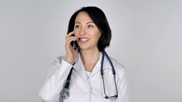 Ärztin-sprechen-auf-Smartphone,-weißer-Hintergrund