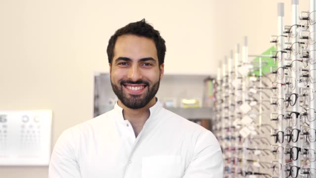 Optician-Doctor-Near-Showcase-With-Eyeglasses-At-Glasses-Shop