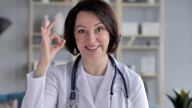 Portrait-of-Old-Lady-Doctor-Gesturing--Okay-Sign