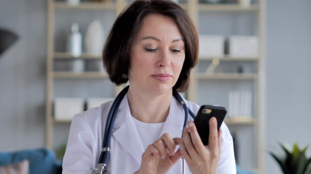 Old-Lady-Doctor-Browsing-Smartphone
