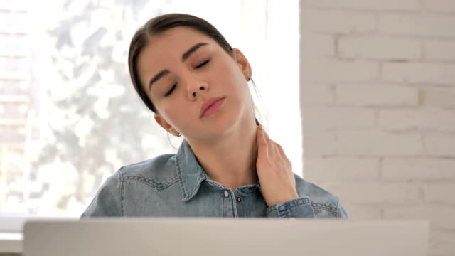 Close-Up-of-Tired-Young-Girl-with-Neck-Pain-at-Work