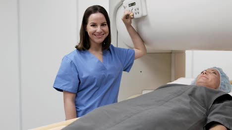 Portrait-Of-Friendly-Successful-Doctor-Smiling-At-Camera-During-MRI