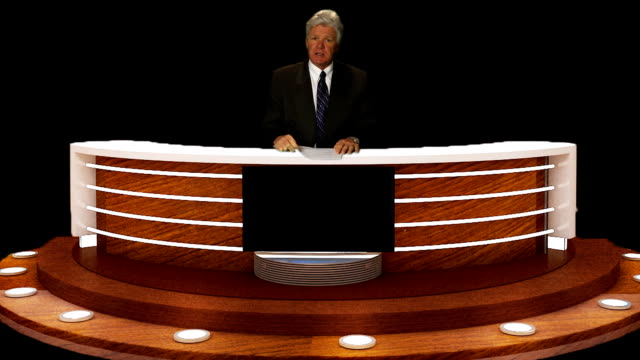NEWS-ANCHORMAN-AT-CONSOLE