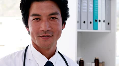 Handsome-young-doctor-smiling-at-camera