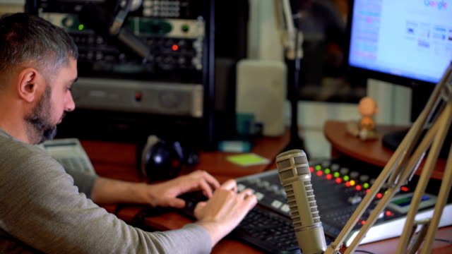 Radio-Moderator-am-Mikrofon-in-einem-live-Radio-broadcast-studio