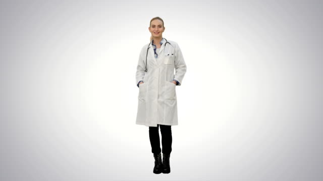 Smiling-beautiful-woman-in-lab-coat-talking-to-the-camera-on-white-background