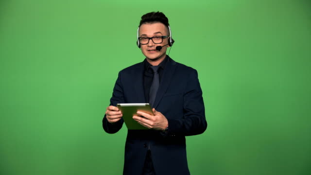 Newscaster-with-tablet-and-headset