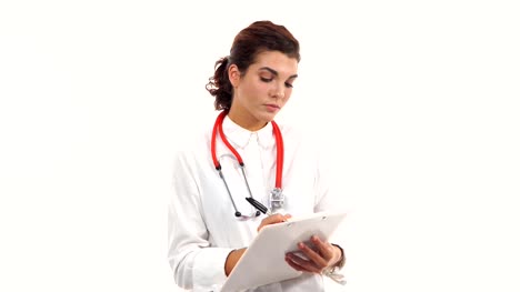Freundliche-junge-Ärztin-Bewertungen-und-Notizen-auf-einem-Klemmbrett-schreibt.-Porträt-des-jungen-Arzt-mit-Stethoskop-und-Lab-Mantel-isoliert-auf-weißem-Hintergrund