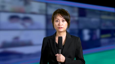 News-anchorwoman-in-studio-with-banks-of-screens-in-background