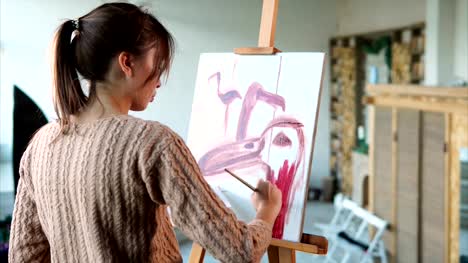 Woman-paints-swift-strokes-of-pink-flamingos-in-different-angles,-she-uses-brush