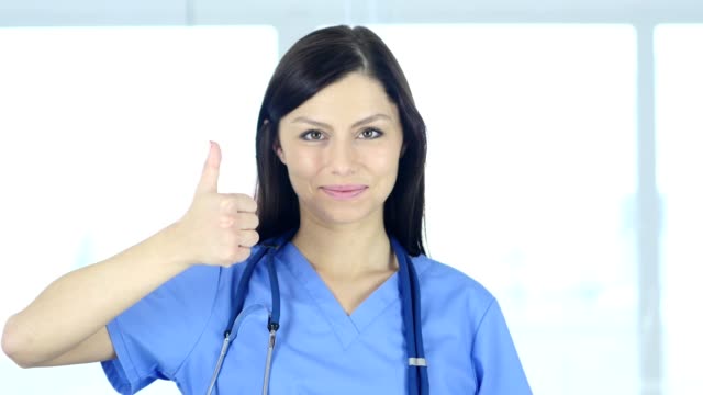 Portrait-of-Thumbs-Up-by-Doctor-in-Clinic