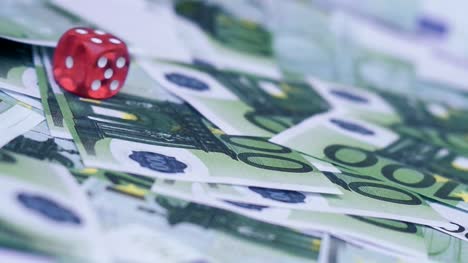 Red-dice-falling-on-euro-money