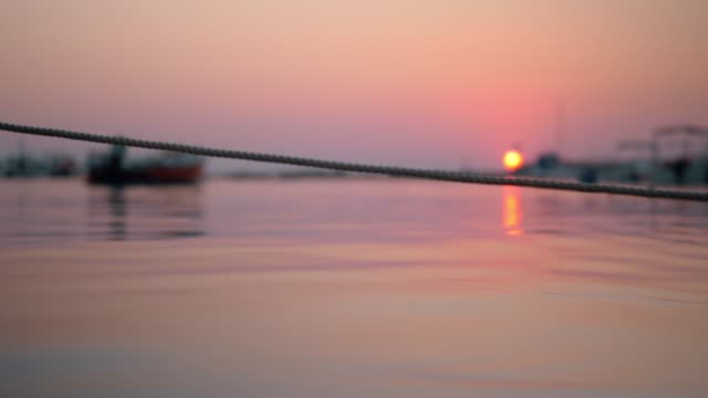 Tied-up-boat-in-the-harbour-at-sunset