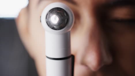 Woman-using-otoscope-for-an-examination,-close-up