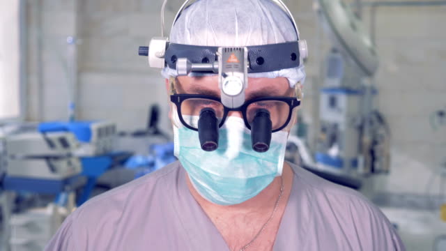 Professionelle-Arzt-hob-seinen-Kopf-und-starrte-unverwandt-in-die-Kamera