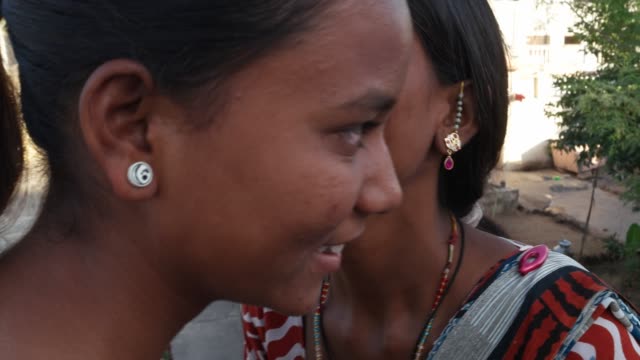 Handheld-Closeup-Aufnahme-von-zwei-schönen-Damen-teilen-und-auf-einer-Terrasse-im-ländlichen-Indien-an-einem-heißen-Sommertag-Klatsch