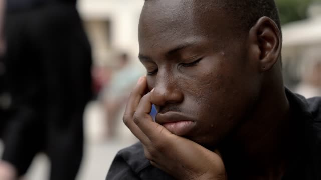close-up-portrait-of-Pensive-american-african-young-man-in-the-street