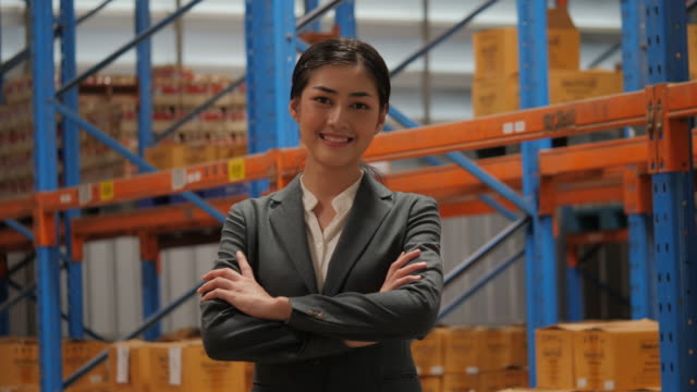 Portrait-of-happy-and-cheerful-businesswoman-in-warehouse