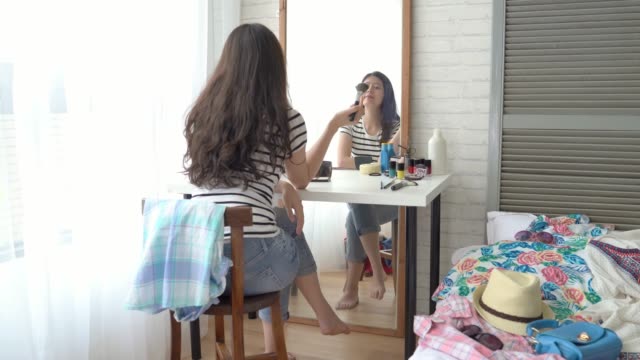 girl-using-her-cell-phone-and-makeup