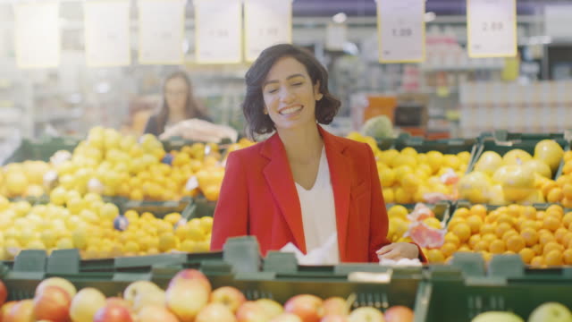 At-the-Supermarket:-Portrait-of-the-Beautiful-Smiling-Woman-Standing-in-the-Fresh-Produce-Sectiomn-of-the-Store,-Choosing-Organic-Fruits-and-Vegetables.
