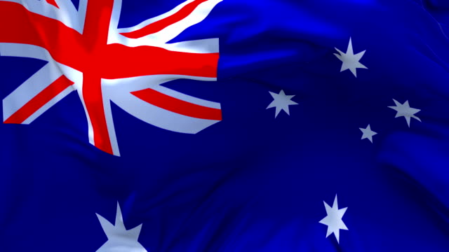 Australia-Flag-Waving-in-Wind-Slow-Motion-Animation-.-4K-Realistic-Fabric-Texture-Flag-Smooth-Blowing-on-a-windy-day-Continuous-Seamless-Loop-Background.