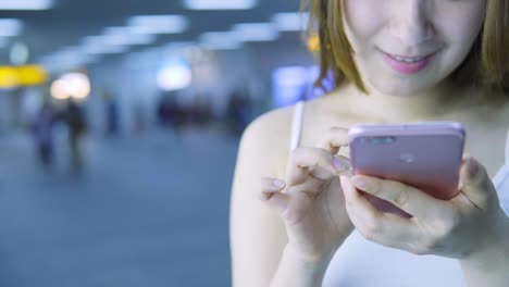 Young-Asian-Woman-Using-Smart-Phone-in-the-City-at-night