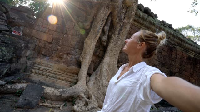Travel-female-taking-selfie-portrait-at-ancient-temple