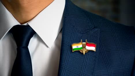 Businessman-Walking-Towards-Camera-With-Friend-Country-Flags-Pin-India---Indonesia