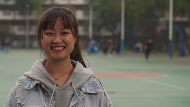 Portrait-of-young-asian-girl-smile-at-camera-in-campus