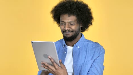 Afro-American-Man-Browsing-Internet,-Using-Tablet