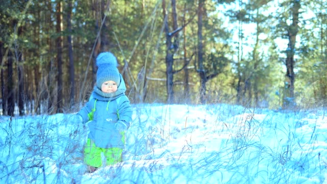 Kid-is-standing-in-a-snowdrift.-Turns-around-and-looks-around.-Winter-day