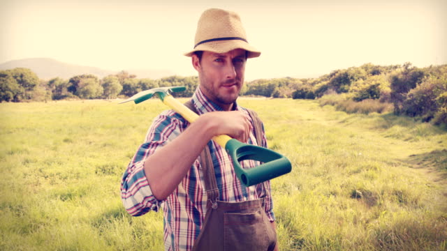 Happy-farmer-holding-a-shovel