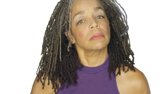 Mature-woman-stares,-on-a-white-studio-background