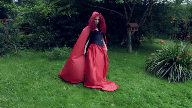 4k-Halloween-Shot-of-Red-Riding-Hood-Leaving-Dramatic-to-the-Forest