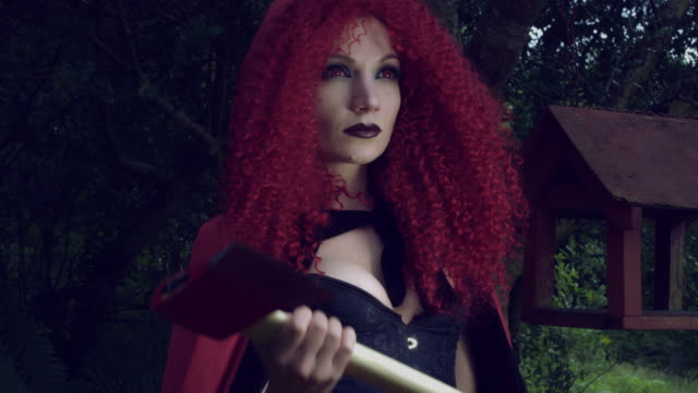 4k-Halloween-Shot-of-Red-Riding-Hood-Posing-with-an-Axe