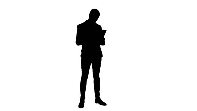 Silhouette-Serious-young-manager-standing-and-reading-documents