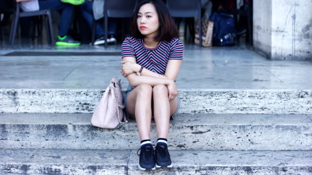 portrait-of-thoughtful-and-bored-Chinese-woman-waiting-for-someone