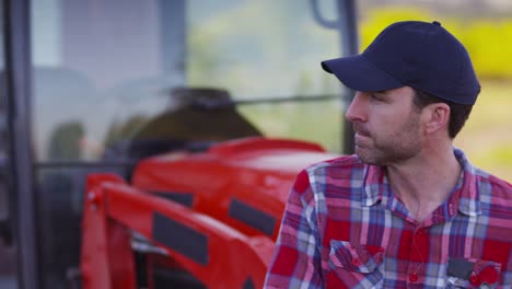 Portrait-of-farmer-sitting-on-tractor