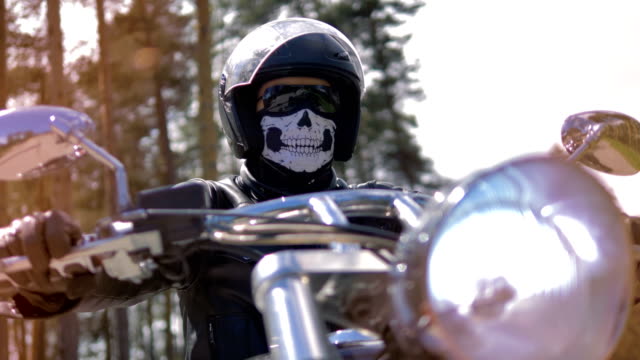 Ein-Mann-sitzt-auf-seinem-Motorrad-Schutzausrüstung-tragen.