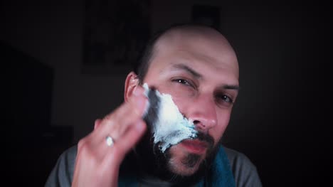 4K-Man-Looking-in-Mirror-and-Putting-Shaving-Foam