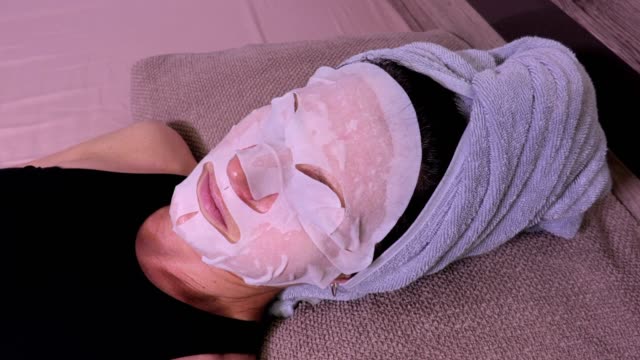 Moving-camera-focusing-on-woman-with-facial-mask