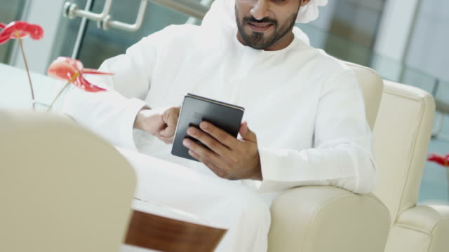 Portrait-Arabic-male-business-consultant-tablet-downtown-hotel